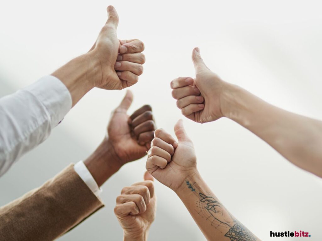 Multiple hands give thumbs-up gestures.