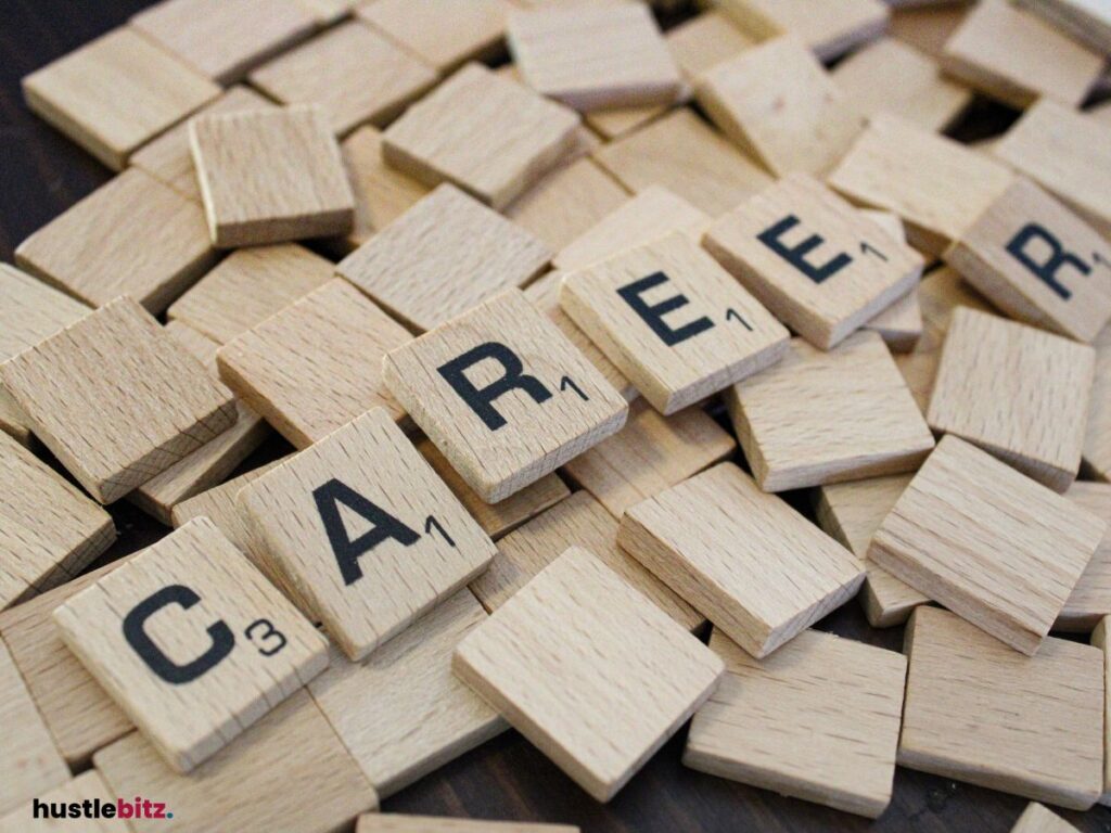 Scrabble tiles spell "CAREER" among wooden tiles scattered across the background.