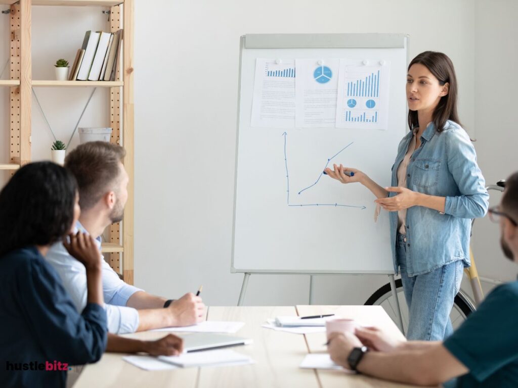 A woman standing while talking and others are listening