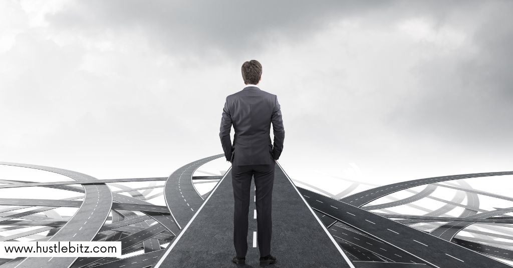 A man in a suit standing on a straight road, facing series of complex and intertwining roads ahead.