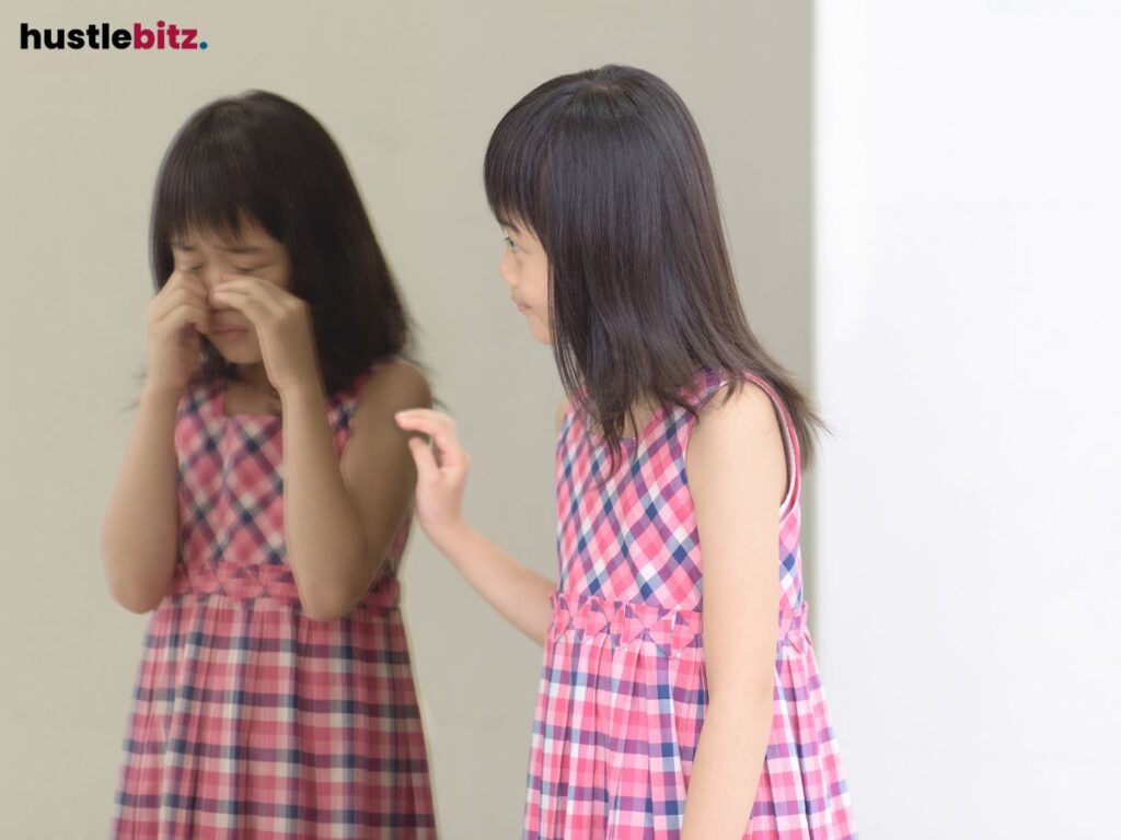 Girl comforting her reflection in the mirror.