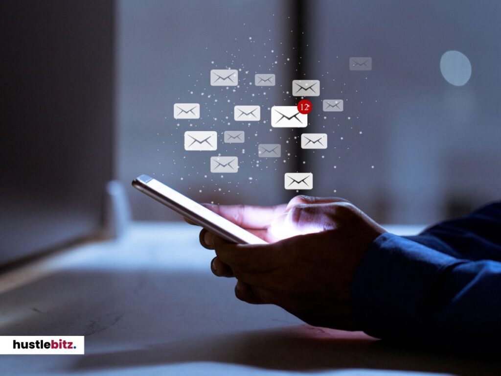 A hand holding gadgets and email icon