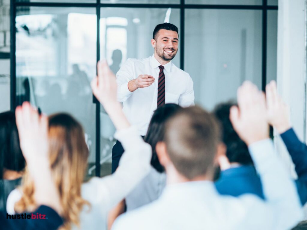 A man standing in front of everyone and smiles