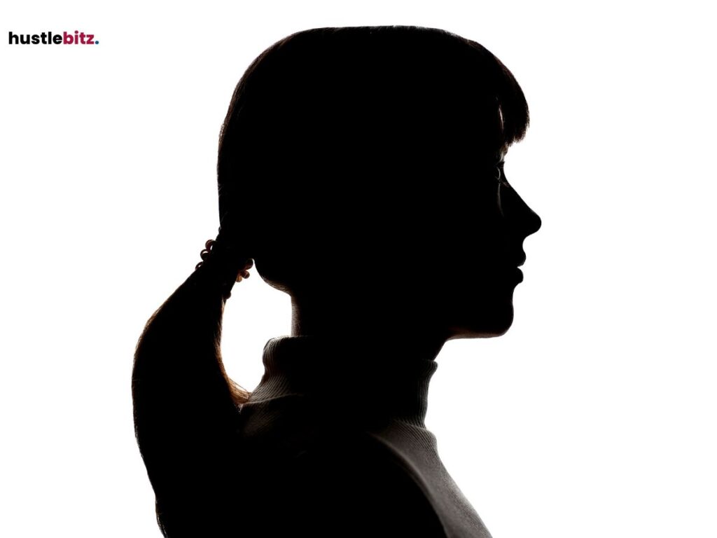 A silhouette of a woman’s face in profile, isolated on a white background.