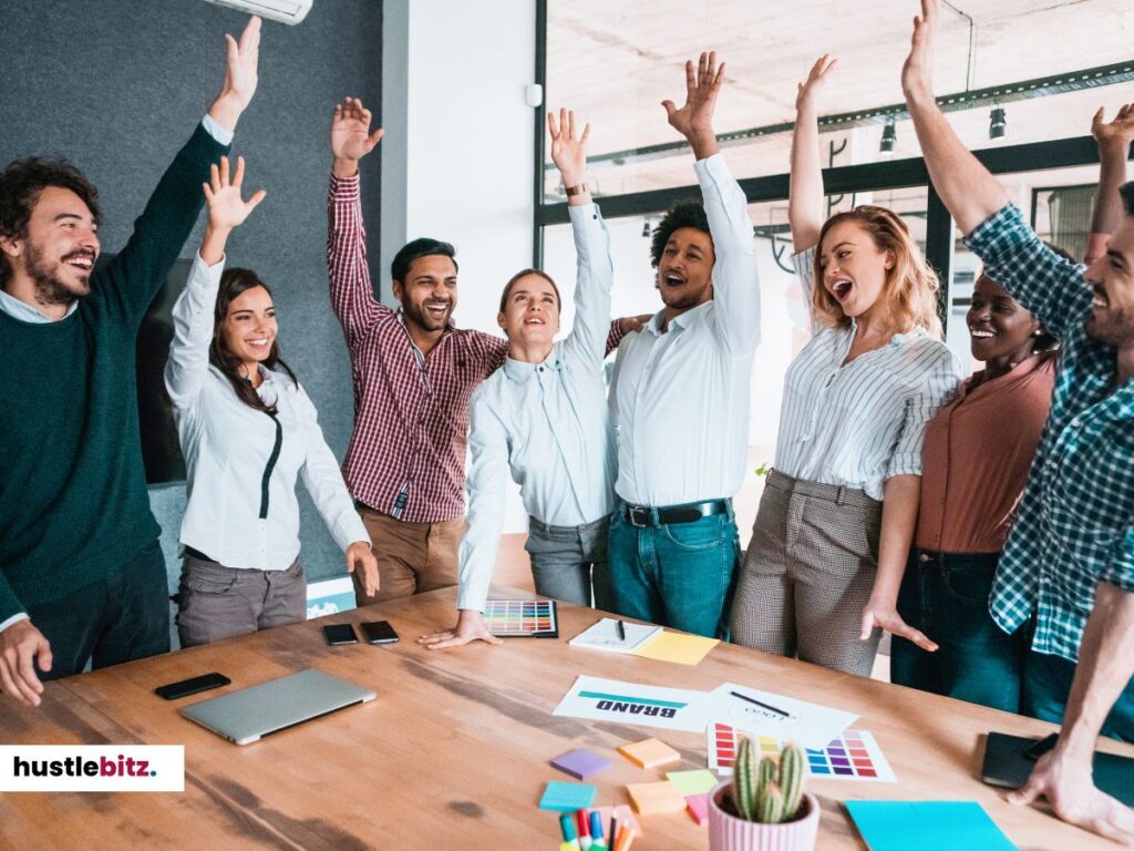 A diverse group of people celebrating together in the office.