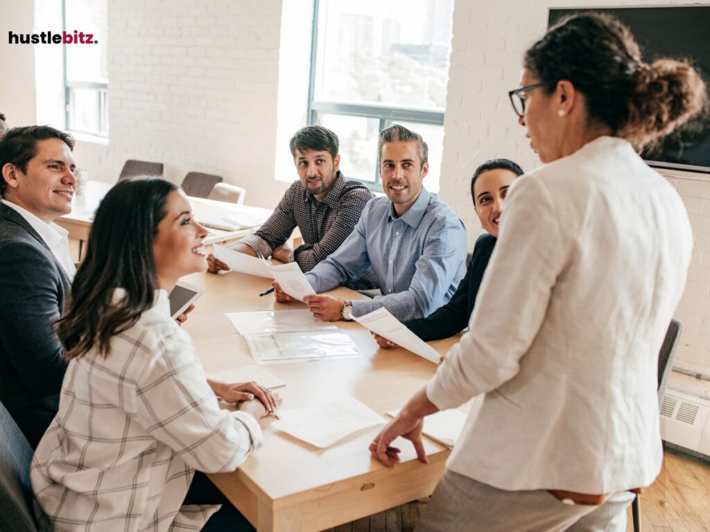 A group of professionals in a meeting, attentively listening to a leader.