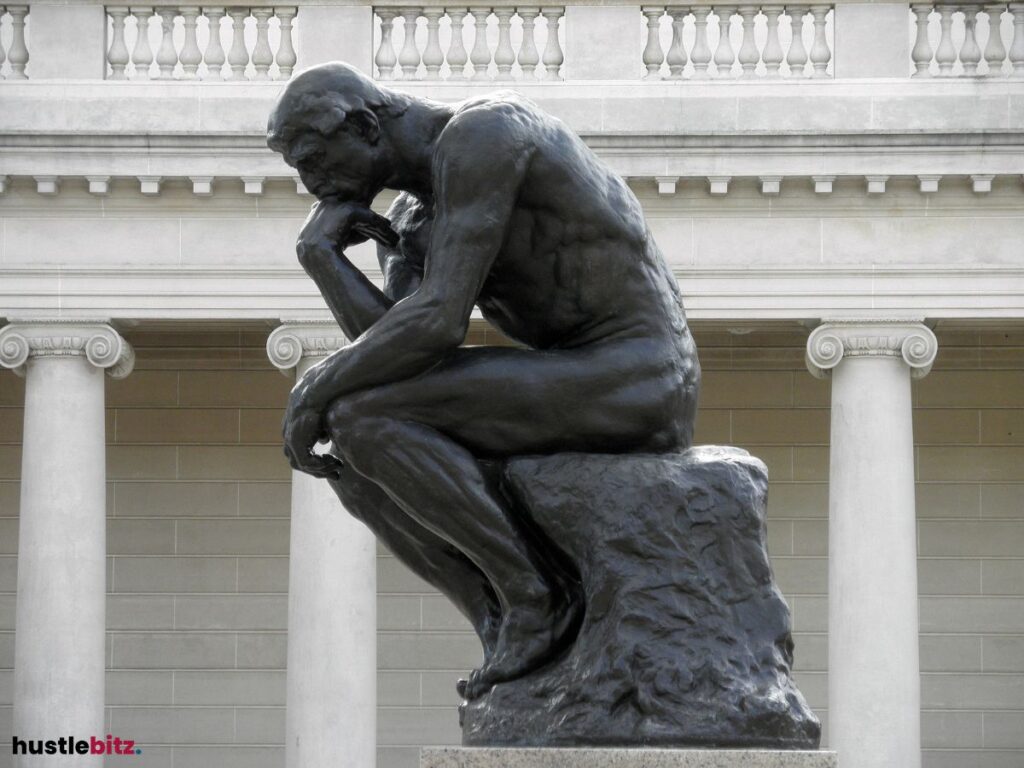 Famous sculpture of a man deep in thought, conveying reflection.