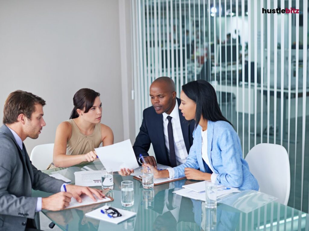 a group of people talking inside the office