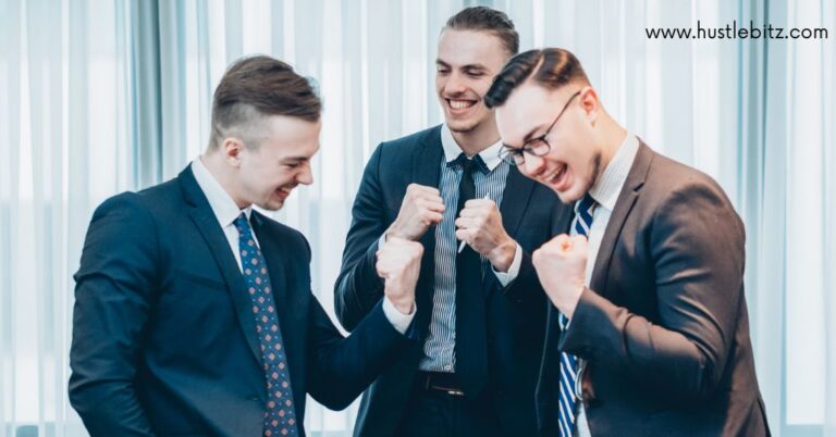 Three business man celebrating a win.