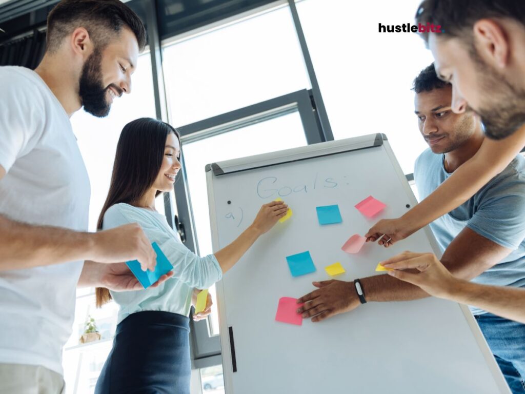 A group of people holding sticky notes and a bulletin board