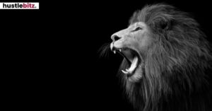 A roaring lion in profile against a black background.