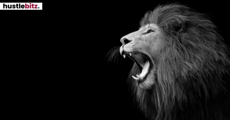 A roaring lion in profile against a black background.