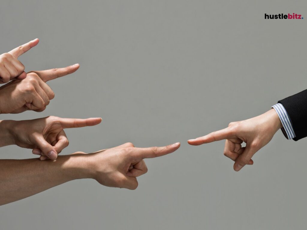 Multiple hands pointing in to one.