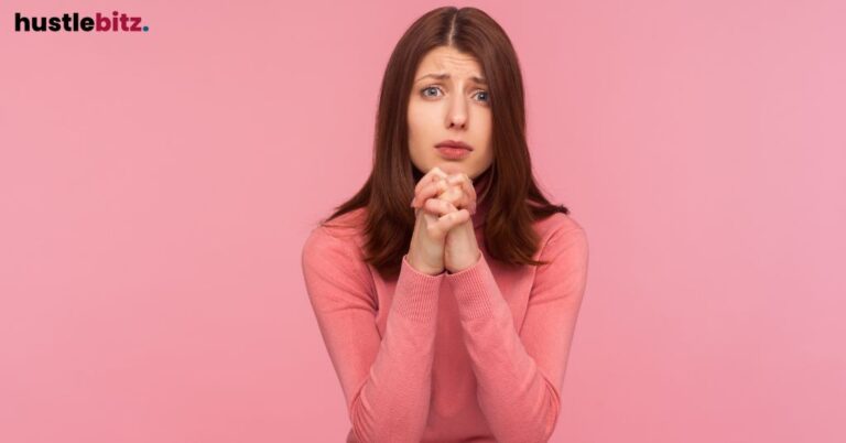 A woman in a pink background pleading.
