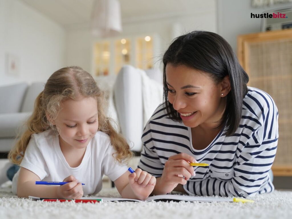 A mother and daughter lying on the ground coloring the book.