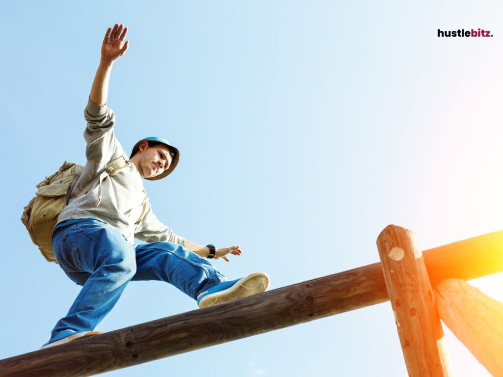 A man balancing on a wooden beam, arms spread, with a backpack.