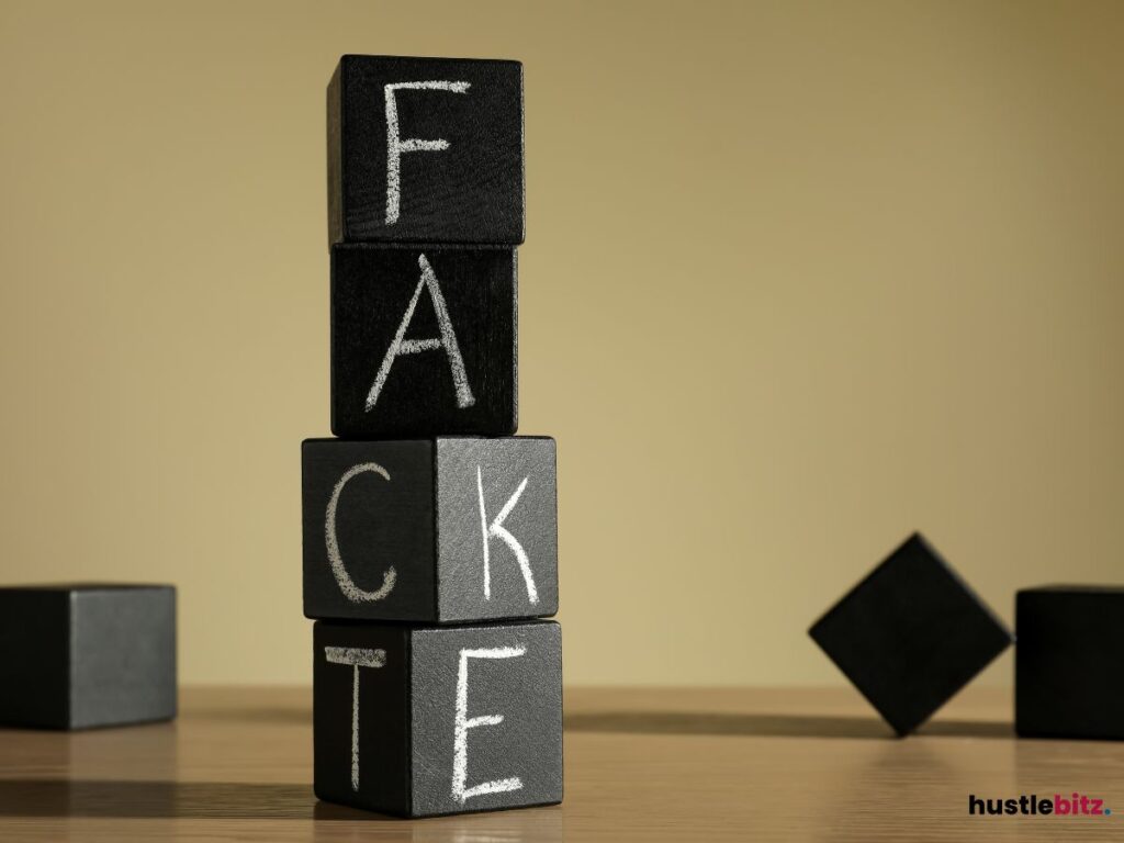 Blocks with the word "Fact" and "Fake" forming, with letters scattered around.