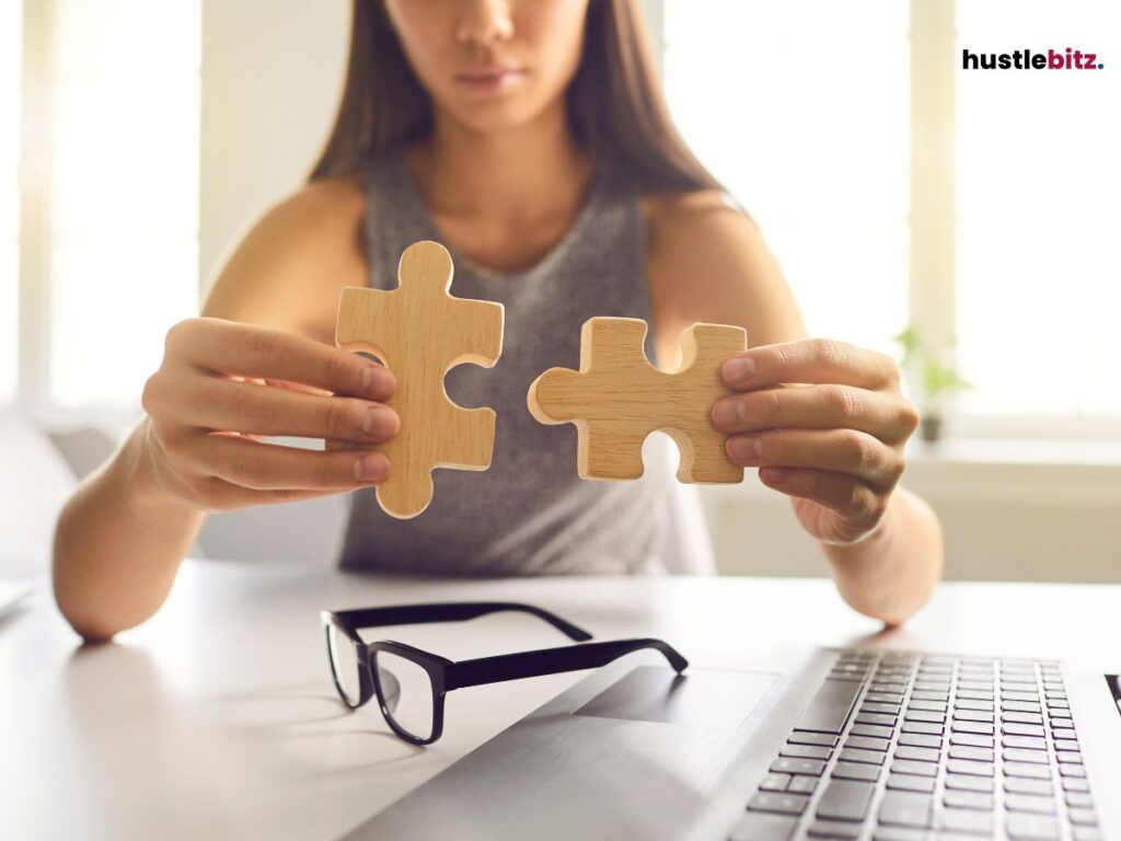 A woman holding a pieces of puzzle and a eyeglass 