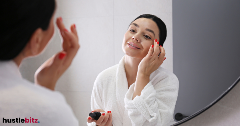 A woman doiing her make up in the mirror.