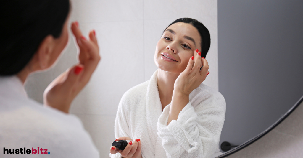 A woman doiing her make up in the mirror.