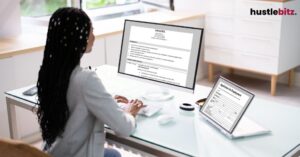 A woman typing the keyboard of the monitor and a tablet with application site
