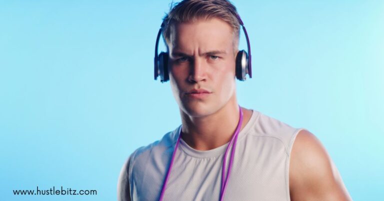 A focused man wearing headphones and a sleeveless shirt.