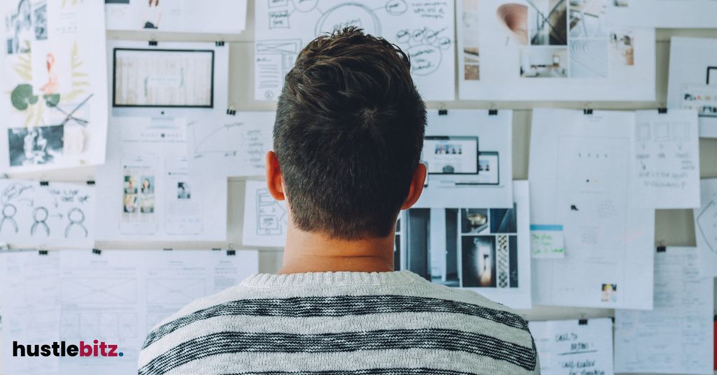 a man looking at the vision board