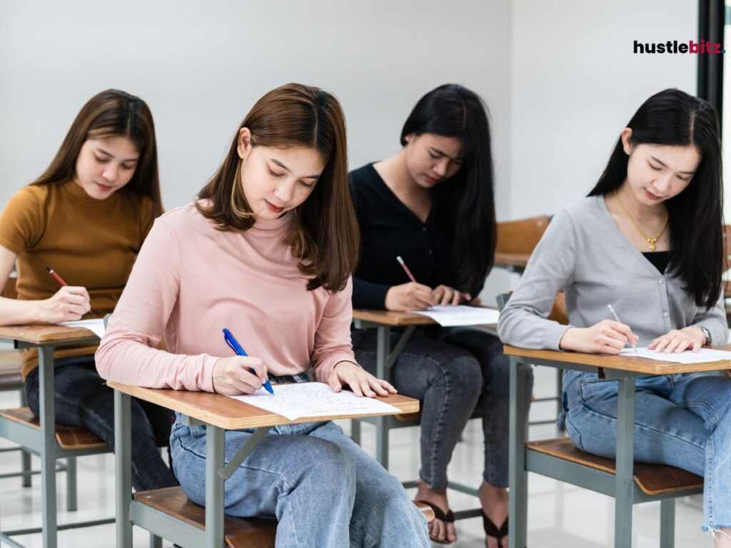 group of people holding pend and a paper in the chair