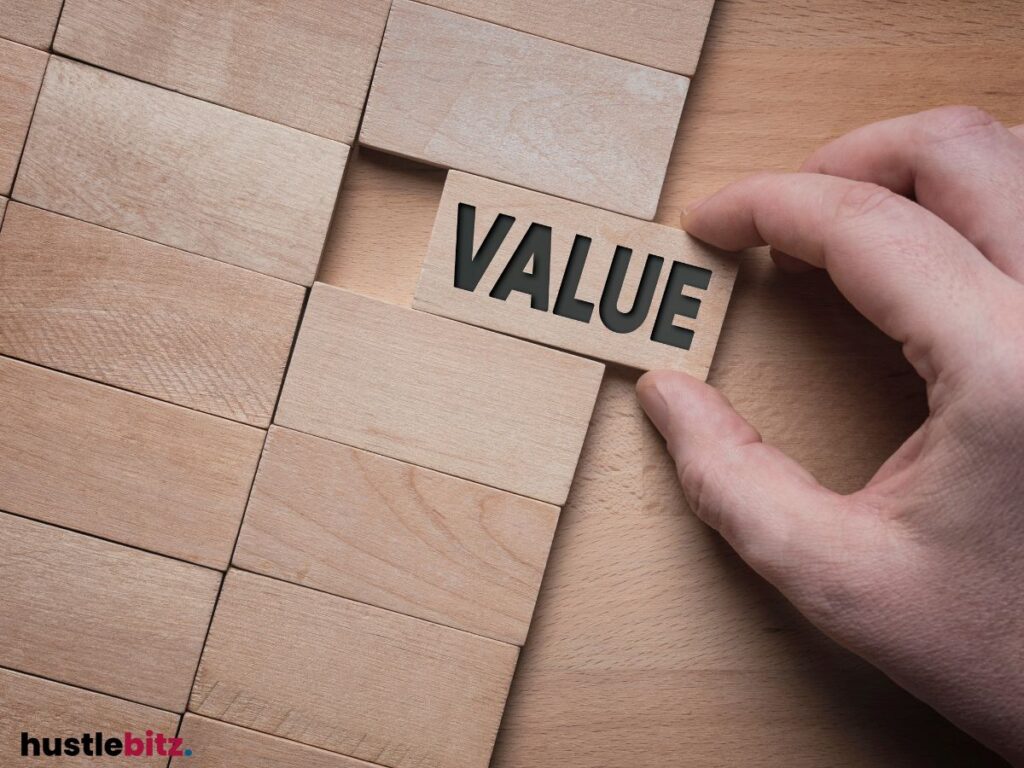 Hand places a wooden block labeled "VALUE" among other blocks.