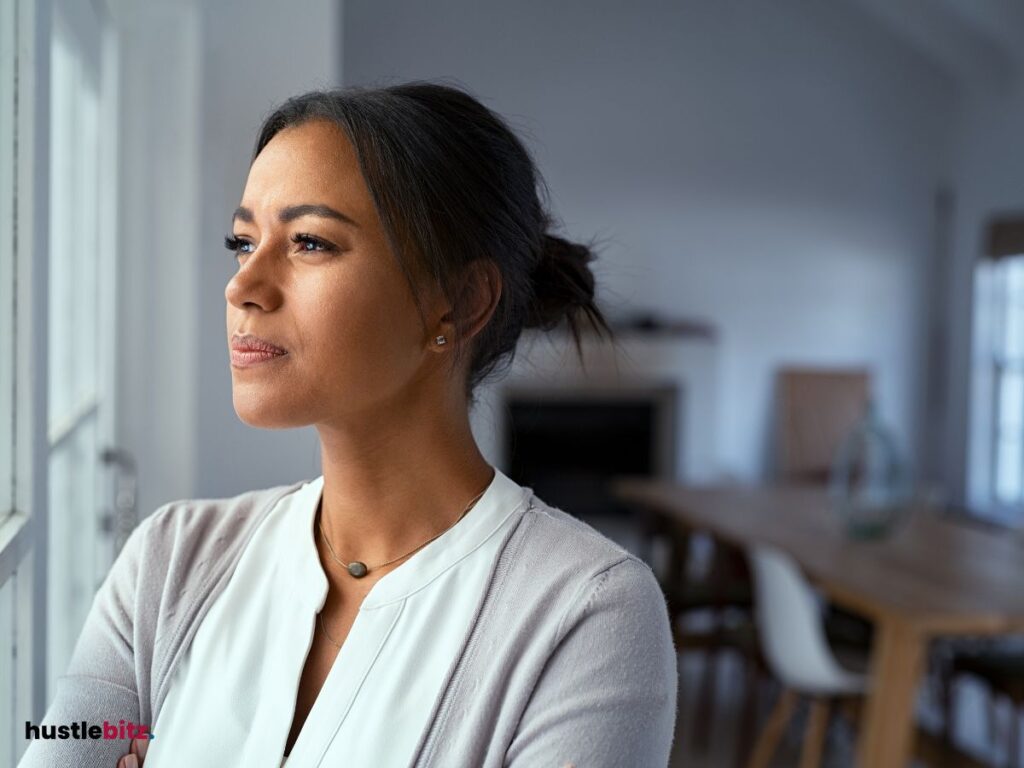 a woman looking at the window inside the house