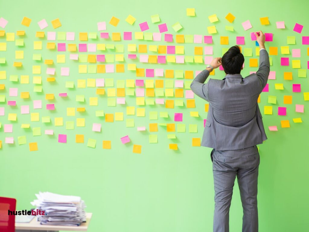 man standing and holding sticky notes