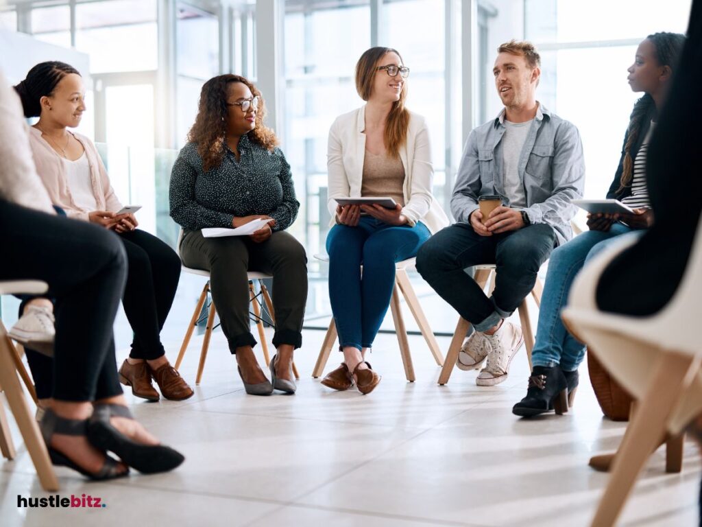 Group of people talking and sitting inside the office