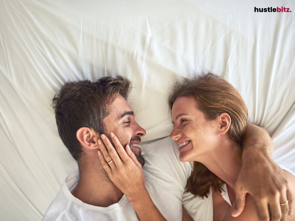 A couple cuddling on the bed.