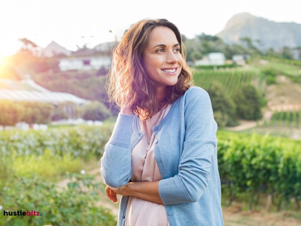 A woman smiles and a nature background