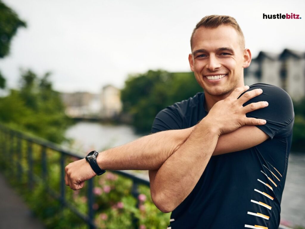 Smiling man stretching outdoors.