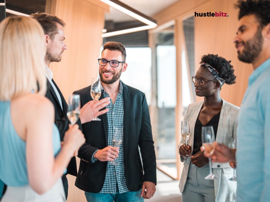 A group of people holding wine glass and smiles