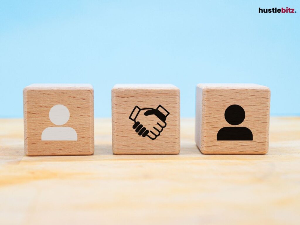 Wooden blocks showing icons of two people and a handshake in between.