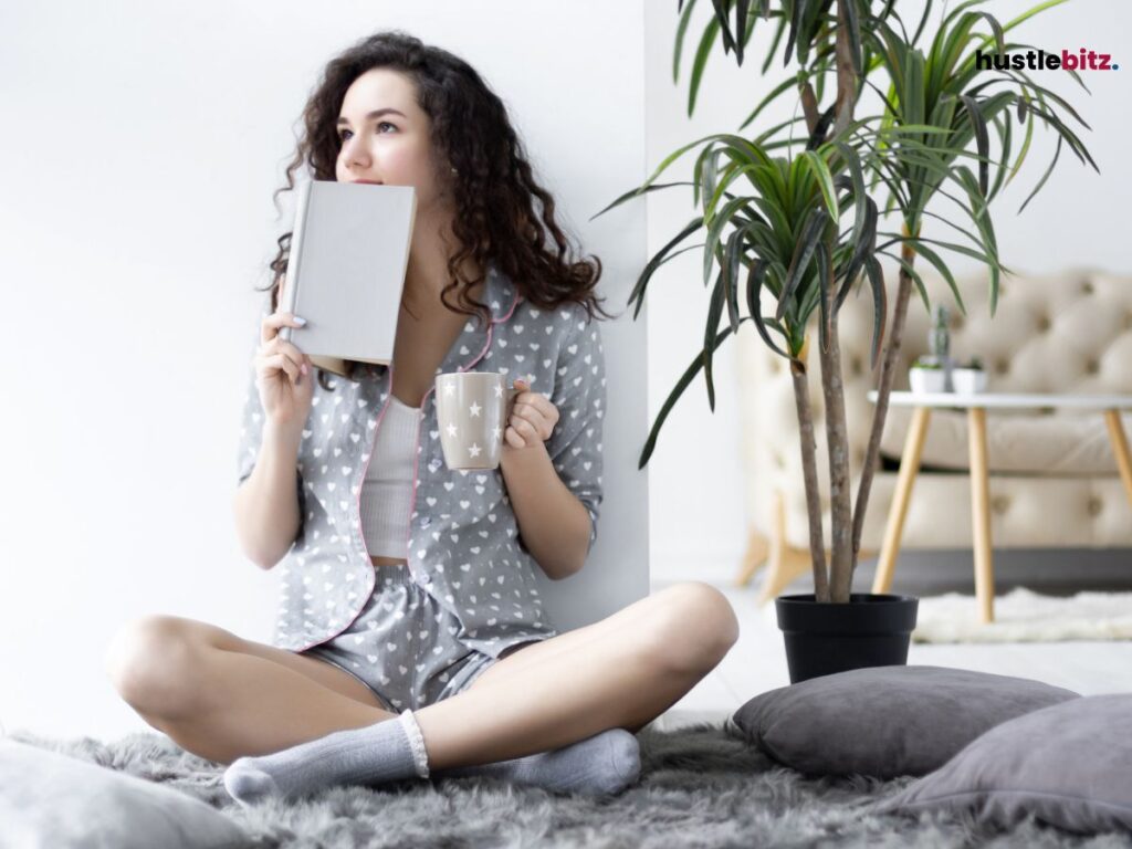 a woman holding a notebook and a coffee