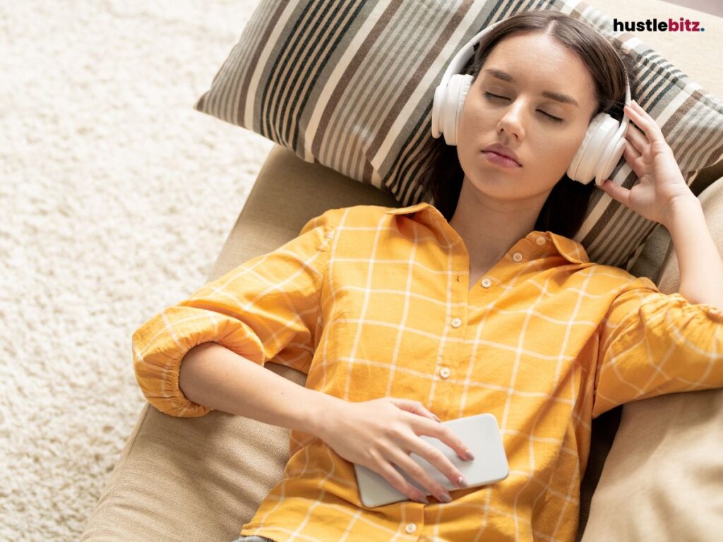 A woman wearing headphone and sleep in the couch