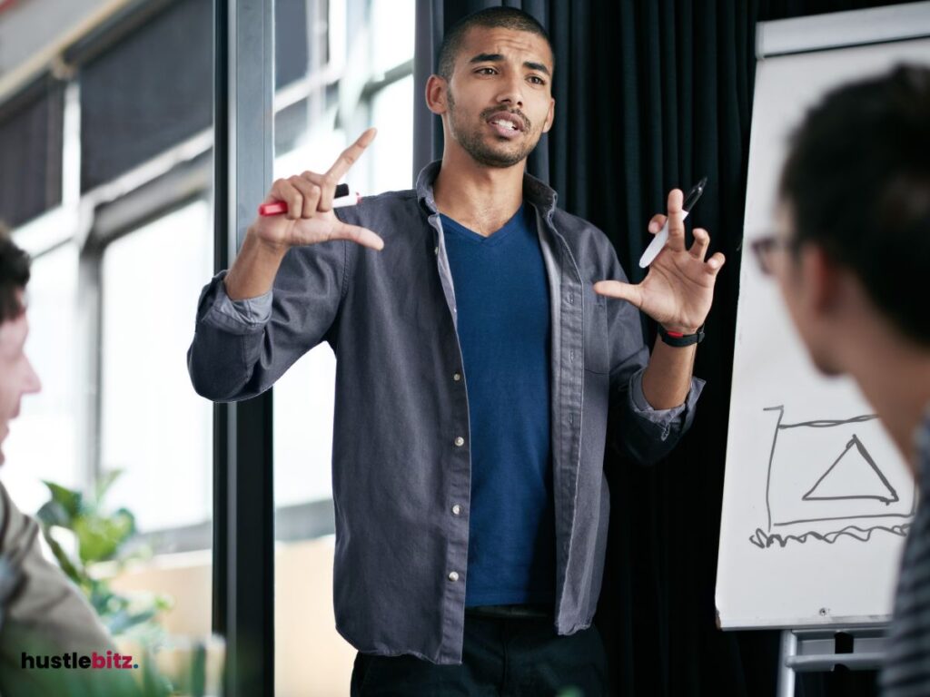 A man talking in front of everyone inside the office