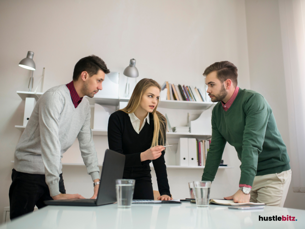 three people talking inside the office