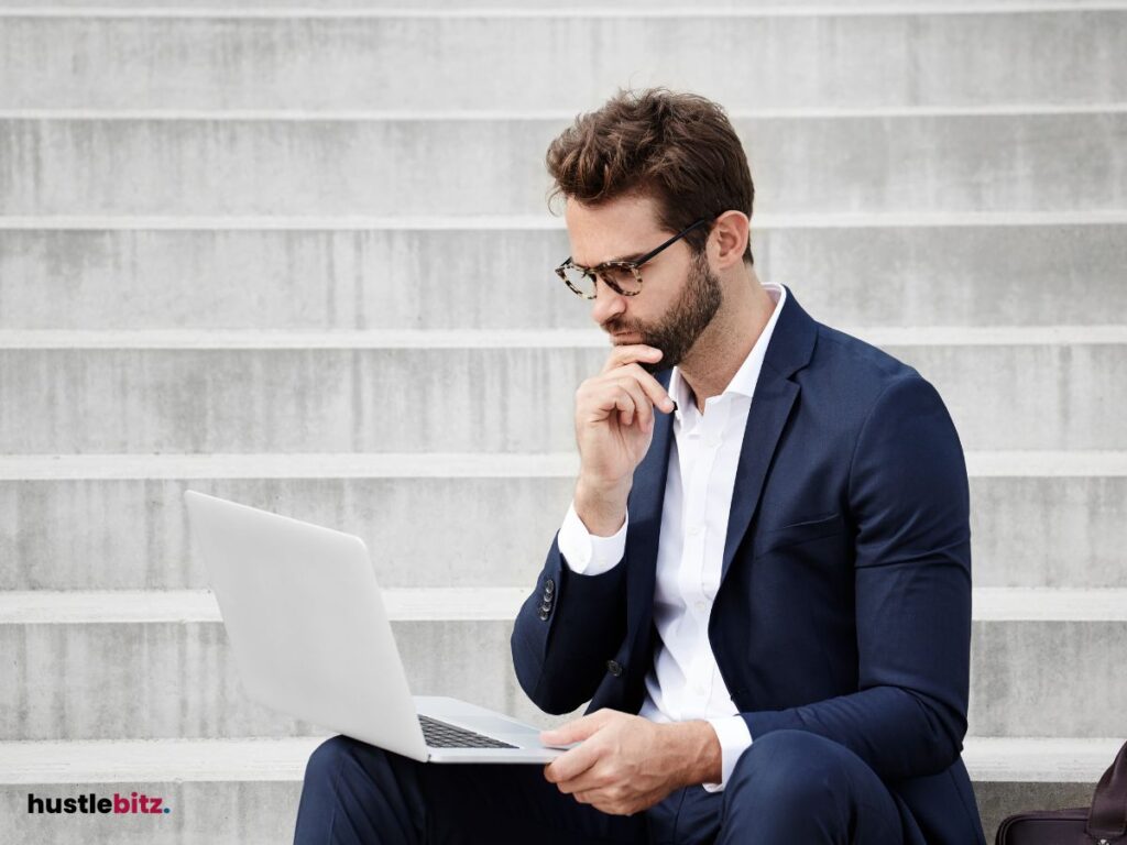 A man holding his chin and a laptop