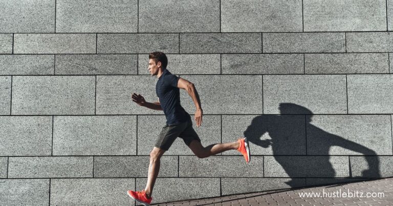 A man in deep focus running in an urban setting.