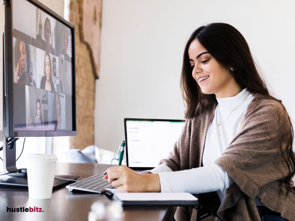 A woman doing writing in front of the monitor