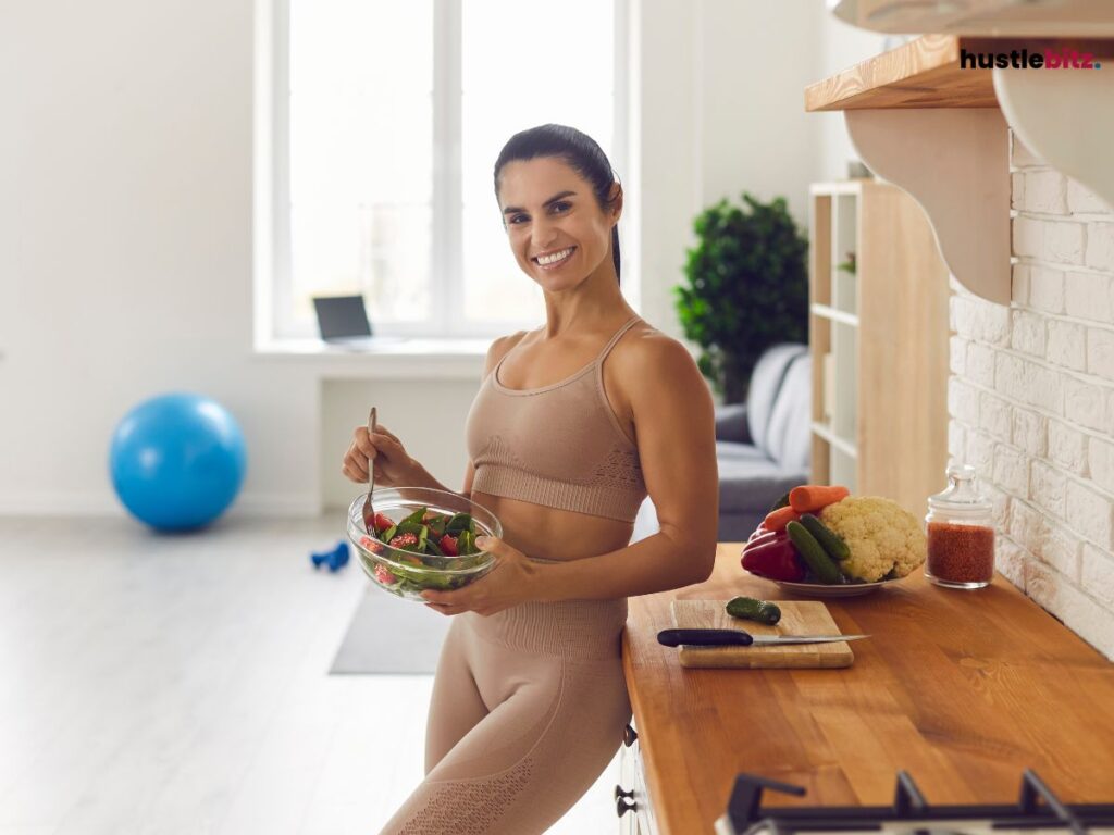 A woman holding a food inside the kitchen room
