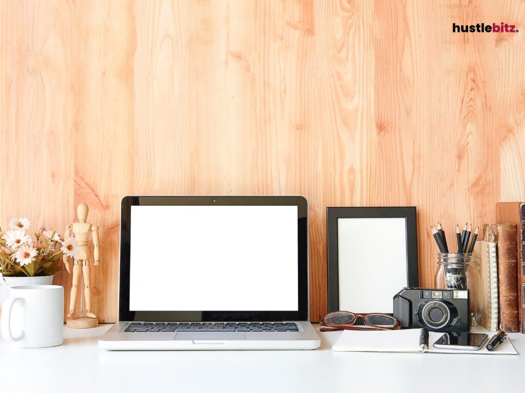 A table with laptop, tablet, camera and etc.