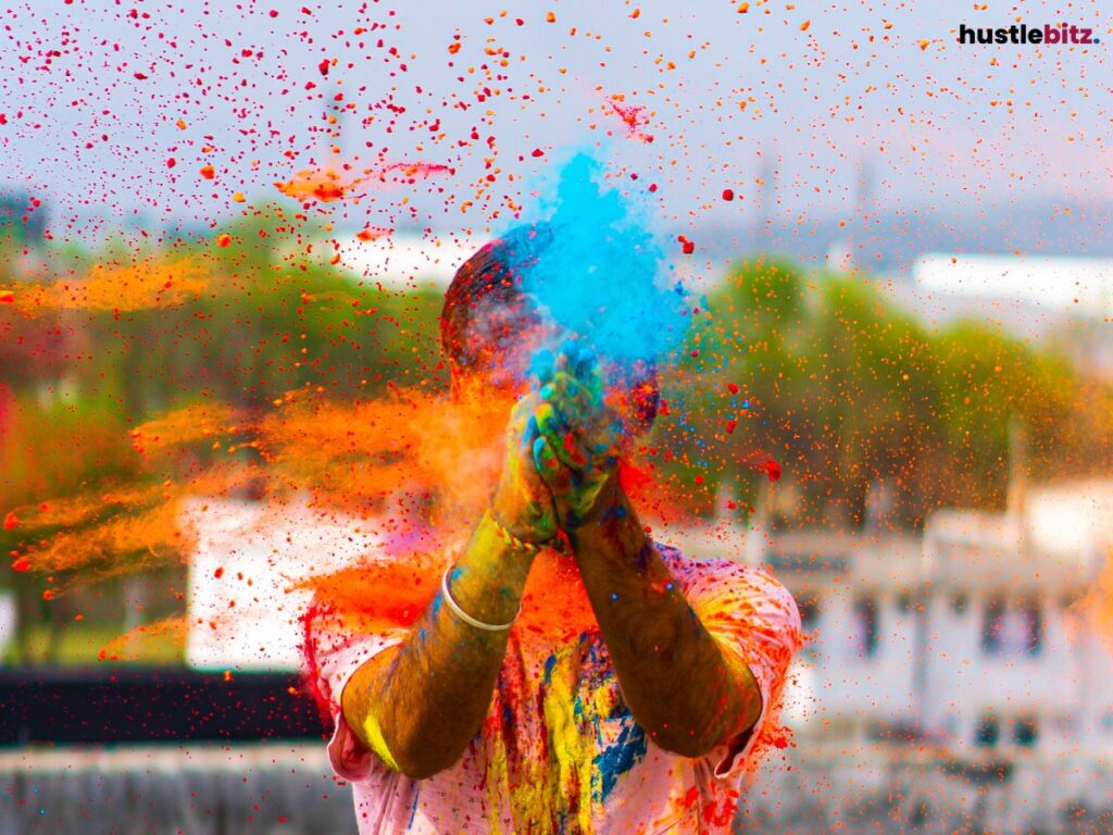 A vibrant scene of a person splashing colorful powder into the air.