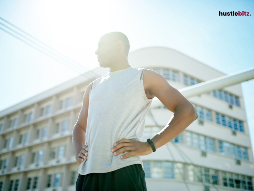 Man standing confidently outside, looking into the distance.