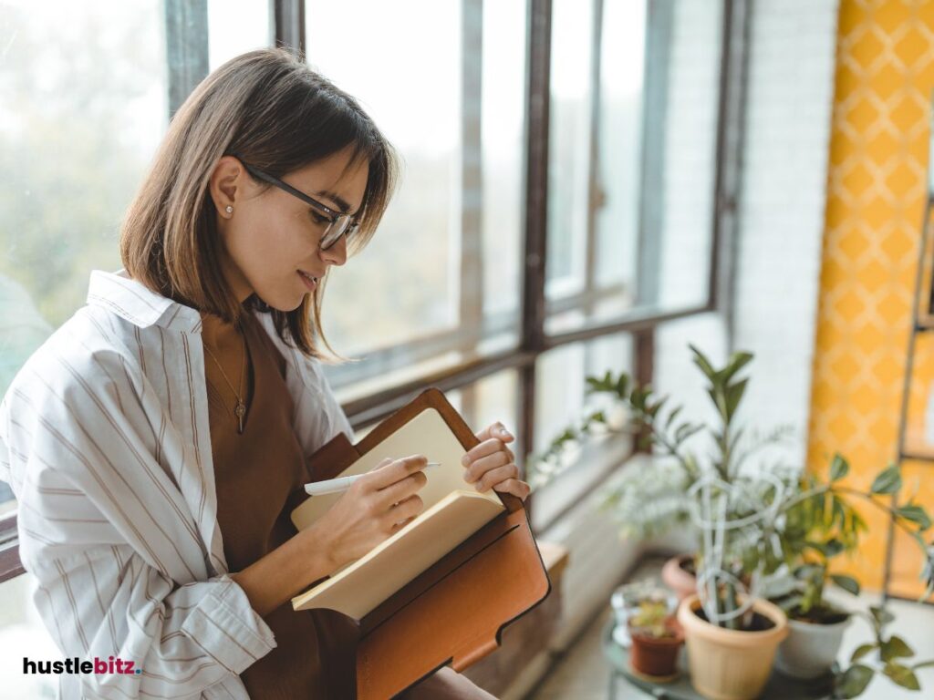 A woman wearing eyeglass doing writing