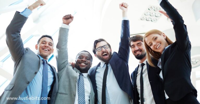 A group of workers shouting and raising their fist celebrating.